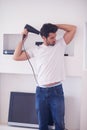 Handsome man using hairdryer Royalty Free Stock Photo