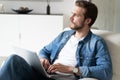 Handsome man using laptop computer at home. Online shopping, home work, freelance, online learning, studying concept Royalty Free Stock Photo