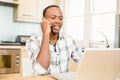 Handsome man using laptop and having a phone call Royalty Free Stock Photo