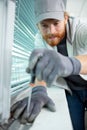 handsome man using screwdriver to install window Royalty Free Stock Photo