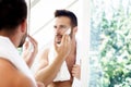 Handsome man using shaving foam before shaving his face Royalty Free Stock Photo