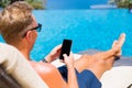 Man using smartphone by the pool. Royalty Free Stock Photo