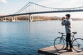 handsome man with vintage film camera and bike standing Royalty Free Stock Photo