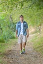 Handsome man walking on forest path Royalty Free Stock Photo