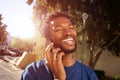 Handsome man walking on street talking on mobile phone Royalty Free Stock Photo