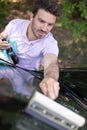 handsome man washing car with sponge and foam Royalty Free Stock Photo