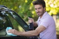 handsome man washing car with sponge and foam Royalty Free Stock Photo