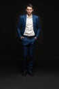 Handsome man wear blue suit isolated on black background. Royalty Free Stock Photo