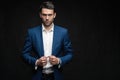 Handsome man wear blue suit isolated on black background. Royalty Free Stock Photo