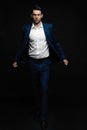 Handsome man wear blue suit isolated on black background. Royalty Free Stock Photo