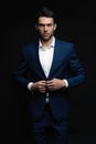 Handsome man wear blue suit isolated on black background. Royalty Free Stock Photo