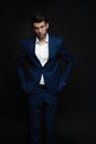 Handsome man wear blue suit isolated on black background. Royalty Free Stock Photo