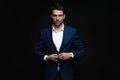 Handsome man wear blue suit isolated on black background. Royalty Free Stock Photo