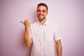 Handsome man wearing elegant summer shirt and sunglasses over pink isolated background smiling with happy face looking and Royalty Free Stock Photo