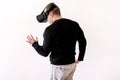 Handsome man wearing and playing virtual reality on isolated white background. Boy action in virtual reality helmet. VR glasses. Royalty Free Stock Photo