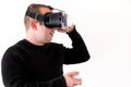 Handsome man wearing and playing virtual reality on isolated white background. Boy action in virtual reality helmet. VR glasses. Royalty Free Stock Photo