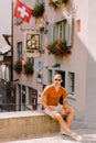 Handsome man wearing sunglasses and shirt walking in old town street Royalty Free Stock Photo