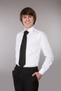 Handsome man in white shirt with black tie keeping hands in pock Royalty Free Stock Photo