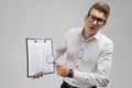 Young man in glasses with insurance and magnifier in hand isolated on white background