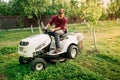 Handsome man, worker using grass cutting equipment for landscaping works Royalty Free Stock Photo