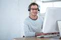 Handsome man working on computer with headset Royalty Free Stock Photo