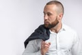 Handsome manful businessman holding his jacket over shoulder on white background