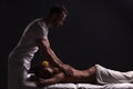 Handsome masseur doing massage for brunette woman