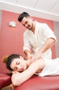 Handsome masseur getting a back massage to his girlfriend