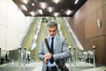 Businessman in front of escalators on a metro station. Royalty Free Stock Photo