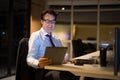 Happy Mature Businessman Sitting And Working In Office At Night Royalty Free Stock Photo