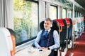 Mature businessman with smartphone travelling by train. Royalty Free Stock Photo