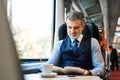 Mature businessman travelling by train. Royalty Free Stock Photo