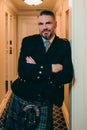 Handsome mature courageous stylish man scotsman in kilt in fancy hotel room. Royalty Free Stock Photo