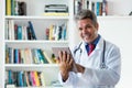 Handsome mature doctor with tablet computer Royalty Free Stock Photo