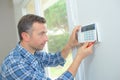 Handsome mature electrician repairing intercom Royalty Free Stock Photo