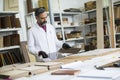 Handsome mature engineer in the laboratory examines ceramic tiles Royalty Free Stock Photo