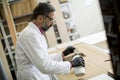 Handsome mature engineer in the laboratory examines ceramic tiles Royalty Free Stock Photo