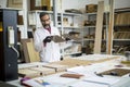 Handsome mature engineer in the laboratory examines ceramic tiles Royalty Free Stock Photo
