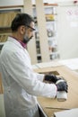 Handsome mature engineer in the laboratory examines ceramic tiles Royalty Free Stock Photo
