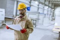 Handsome mature engineer looking at plan in the factory Royalty Free Stock Photo