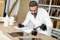 Handsome mature engineer working in laboratory in the furniture Royalty Free Stock Photo