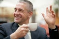 Gray-haired senior businessman drinking cup of coffee