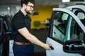 Handsome mature male customer sitting in a new car at the car dealership Royalty Free Stock Photo