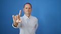 Handsome mature man, in cool casual fashion, seriously gesturing \'no\' with his finger, standing isolated against a stark white Royalty Free Stock Photo