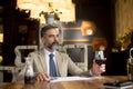 Handsome mature man drinking glass of red wine in restaurant Royalty Free Stock Photo