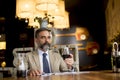 Handsome mature man drinking glass of red wine in restaurant Royalty Free Stock Photo