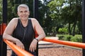 Handsome mature man having rest after exercise on  ground, space for text. Healthy lifestyle Royalty Free Stock Photo