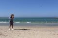 Handsome mature man playing tennis on the beach