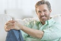 Handsome Mature Man Relaxing On Sofa