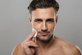 Handsome mature man take care of his skin. Royalty Free Stock Photo